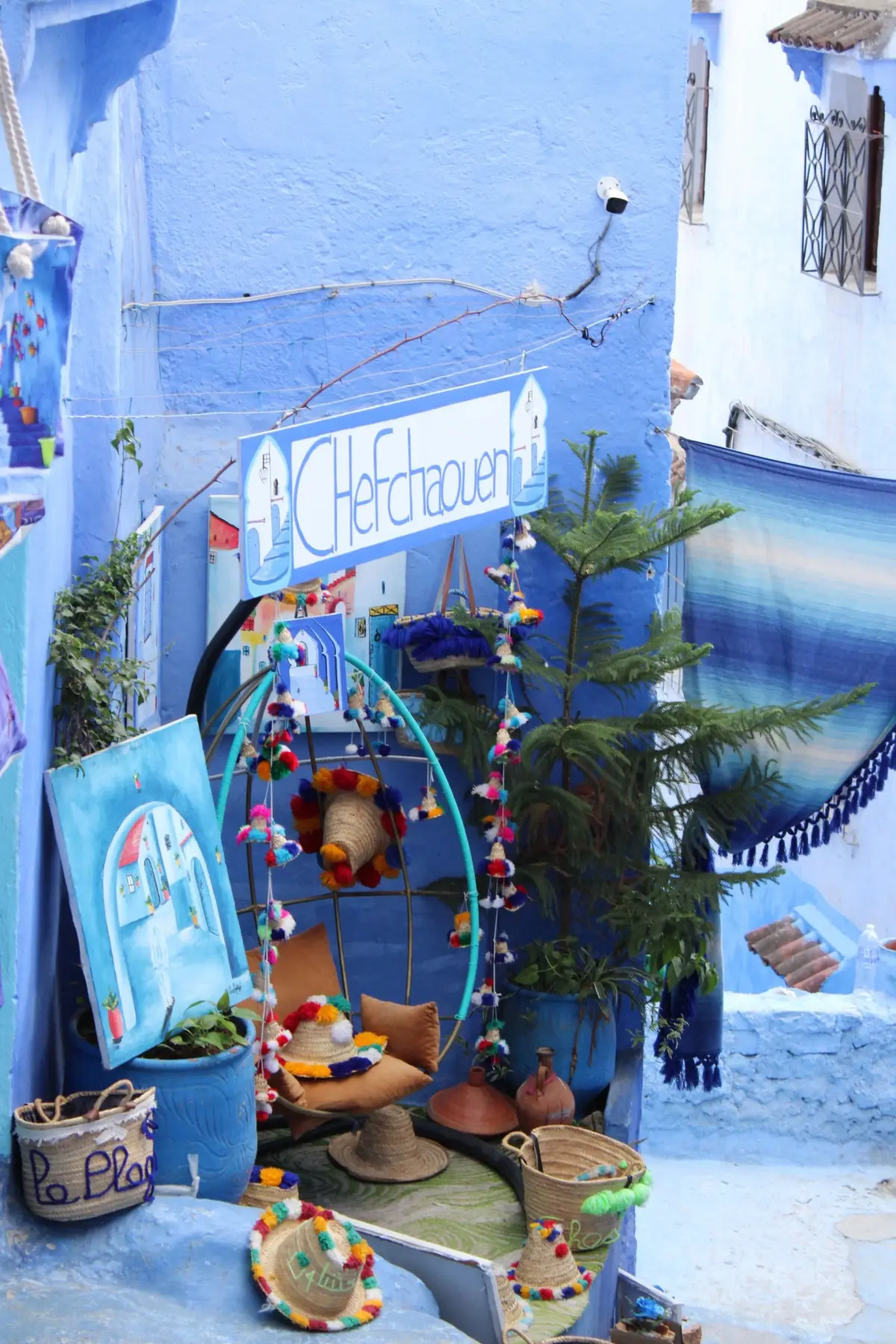 A steep, winding alleyway in Chefchaouen painted entirely in bright blue