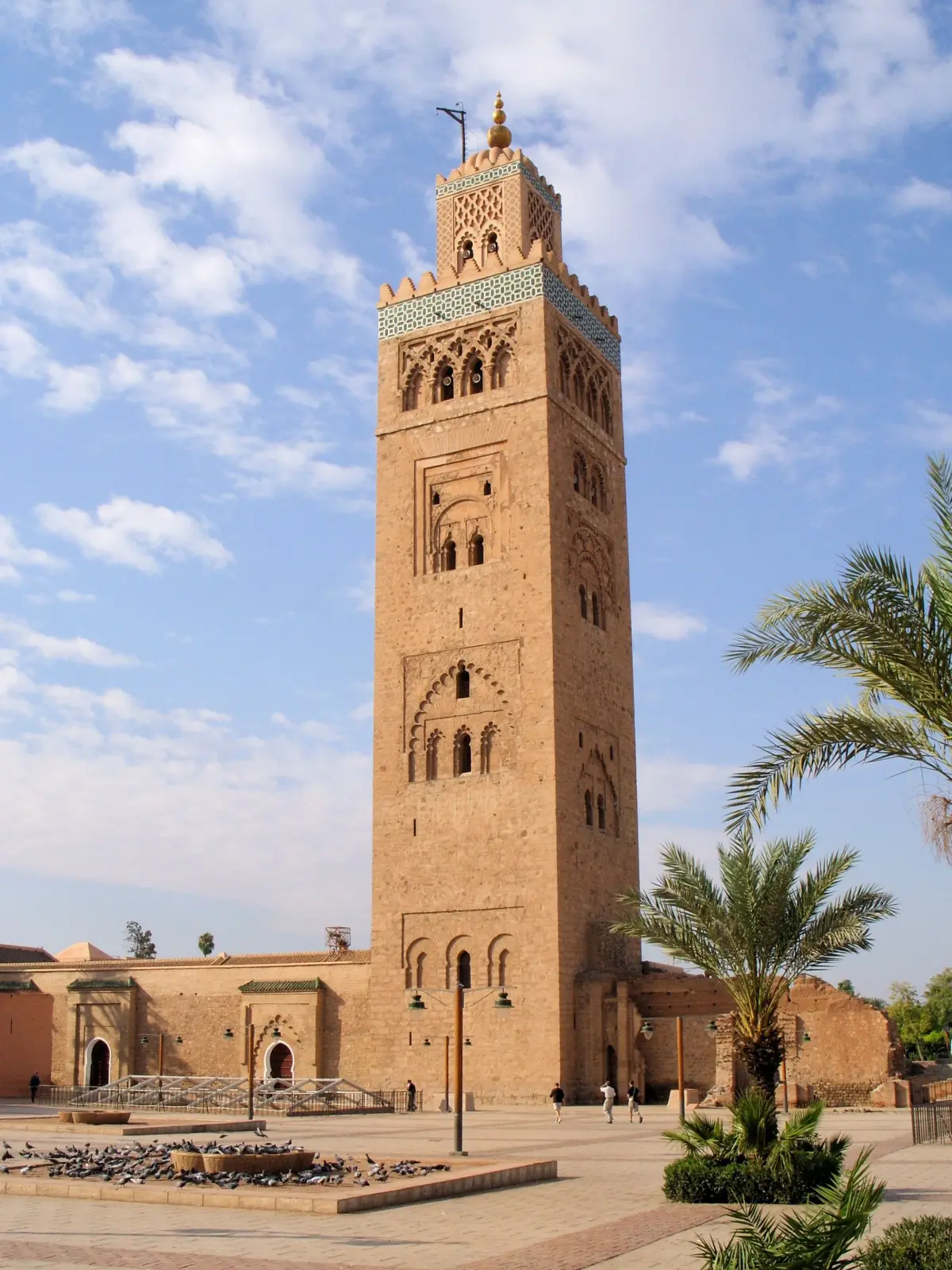 The Koutoubia Mosque minaret towering over palm trees