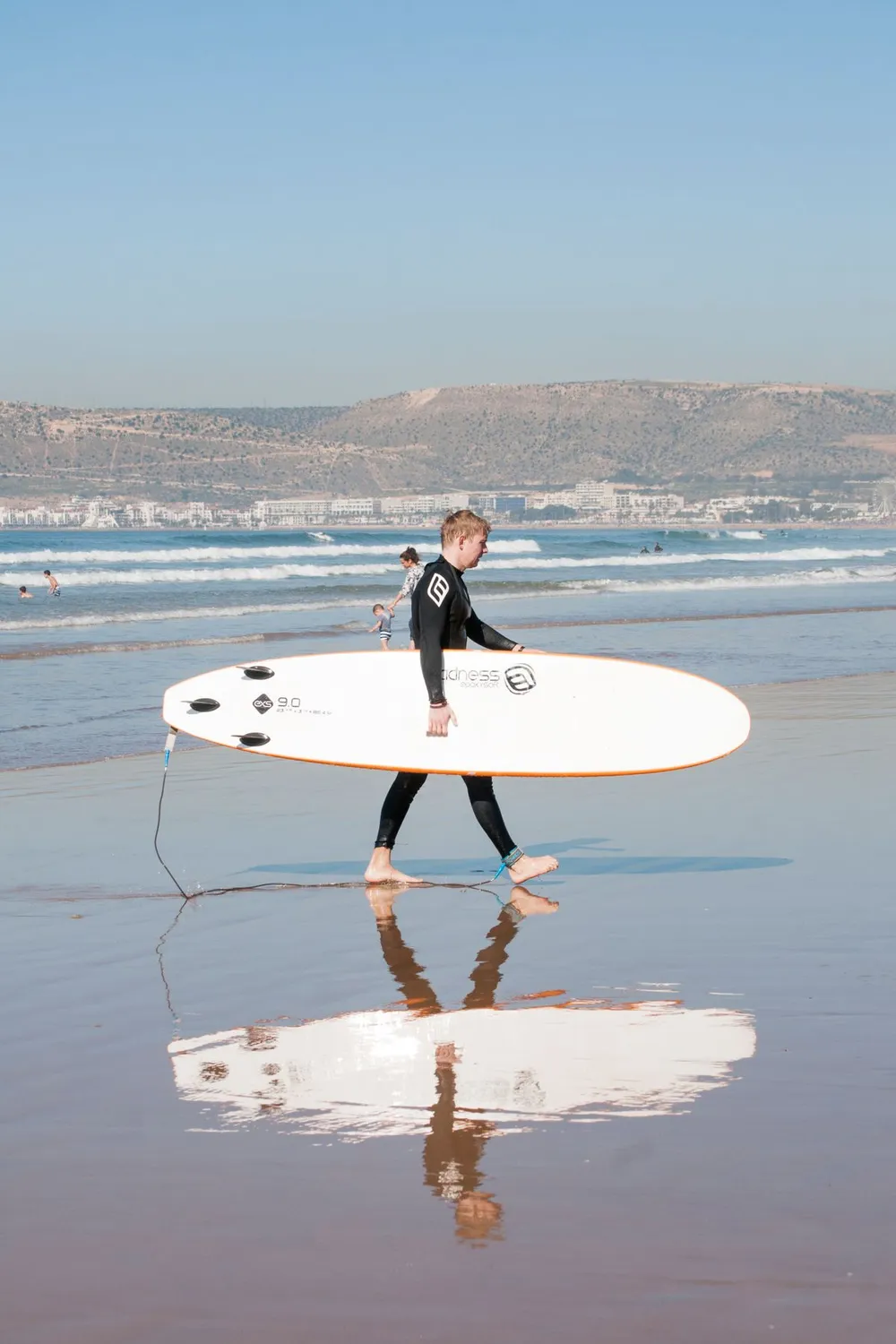 Surfer carrying a board